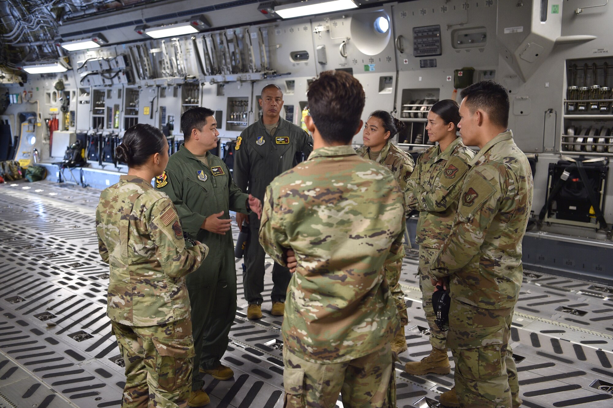 TMaj. Skip Saito and Senior Master Sgt. Brandon Sarceda, both members of the 204th Airlift Squadron, meet with Asian American and Pacific Islander maintenance Airmen from the 15th and 154th Maintenance Groups before taking off on what was for most of them their first C-17 flight, on Joint Base Pearl Harbor-Hickam, Hawaii, May 25, 2021. In honor of Asian American Pacific Islander Heritage Month, the 15th Wing and 154th Wing flew a routine training mission composed with aircrew and maintainers who were all of Asian American or Pacific Islander descent and were a mix of active duty and Air National Guard members. (U.S. Air Force photo by 1st Lt. Amber R. Kelly-Herard)