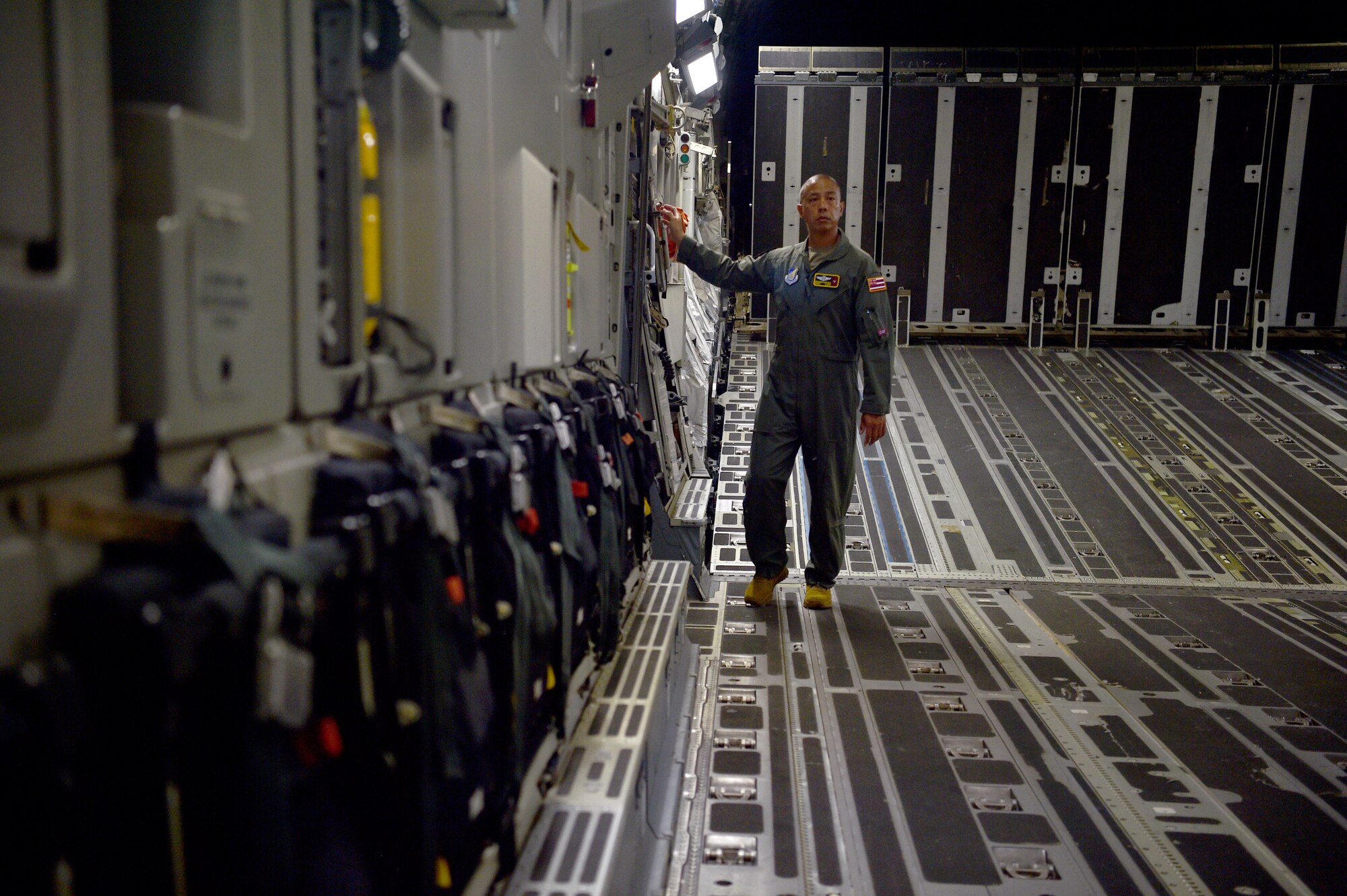 Senior Master Sgt. Brandon Sarceda, 204th Airlift Squadron loadmaster, inspects a C-17 Globemaster before taking off at Joint Base Pearl Harbor-Hickam, Hawaii, May 25, 2021. In honor of Asian American Pacific Islander Heritage Month, the 15th Wing and 154th Wing flew a routine training mission composed with aircrew and maintainers who were all of Asian American or Pacific Islander descent and were a mix of active duty and Air National Guard members. (U.S. Air Force photo by 1st Lt. Amber R. Kelly-Herard)