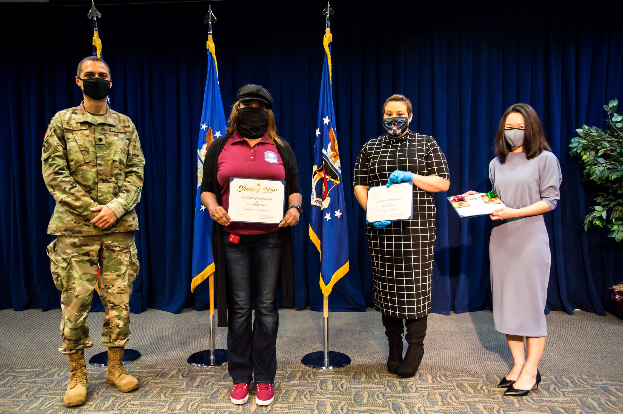 The Sexual Assault Prevention Response (SAPR) team receives the Shining Star Award presented by Lt. Col. John Francis, 61st Air Base Group IMA to the Deputy Commander, during the Los Angeles Air Force Base Volunteer Appreciation ceremony in the Gordon Conference Center April 15, 2021.  (U.S. Space Force photo by Van Ha)