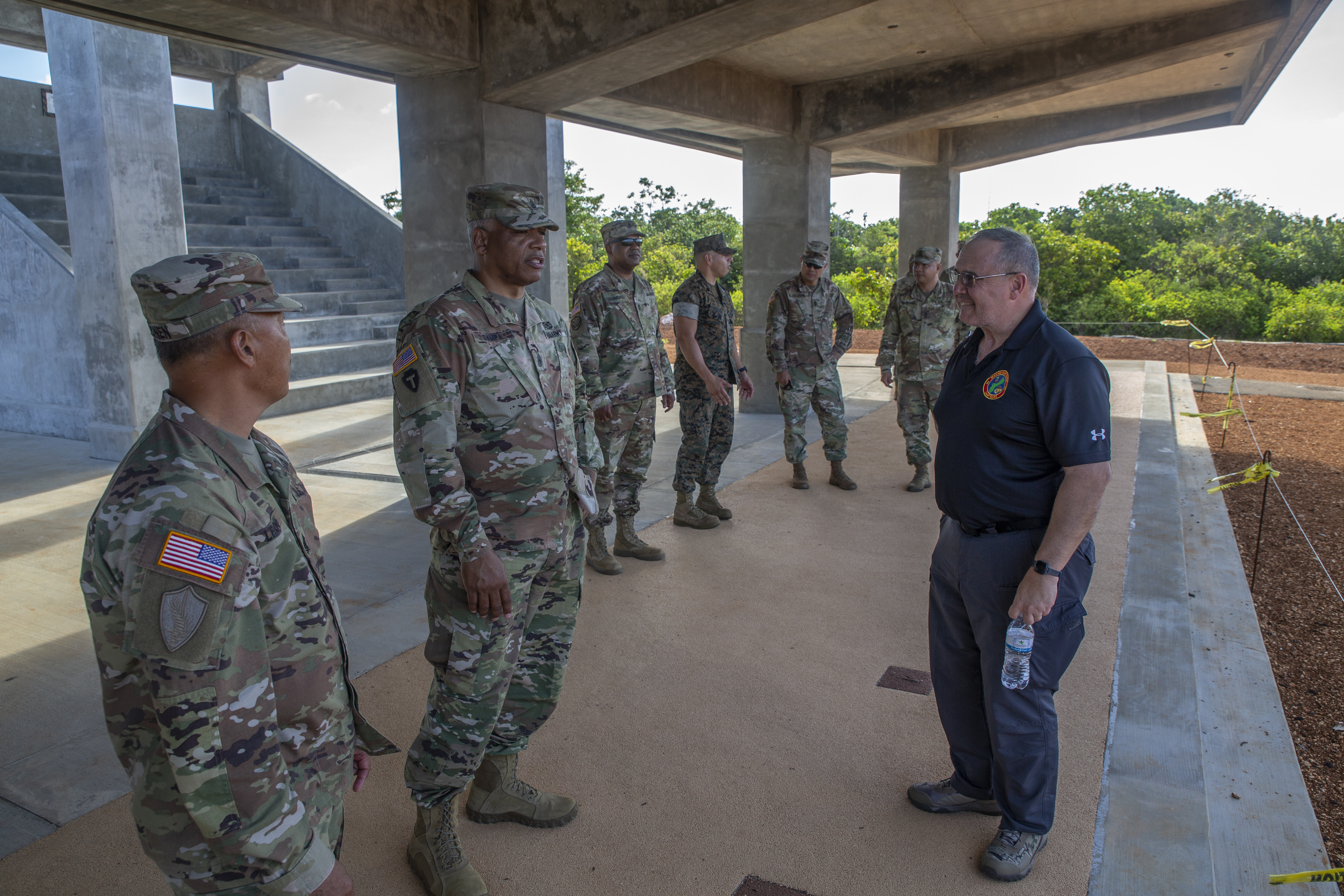 Dave Bednarcik, the Marine Corps Base (MCB) Camp Blaz Range Management Officer, right, briefs Command Sgt. Maj. of the Army National Guard John Sampa, center, and Command Sgt. Maj. Celso Loenen, the Guam National Guard Command Sergeant Major, left, during a visit to MCB Camp Blaz, May 26, 2021.
