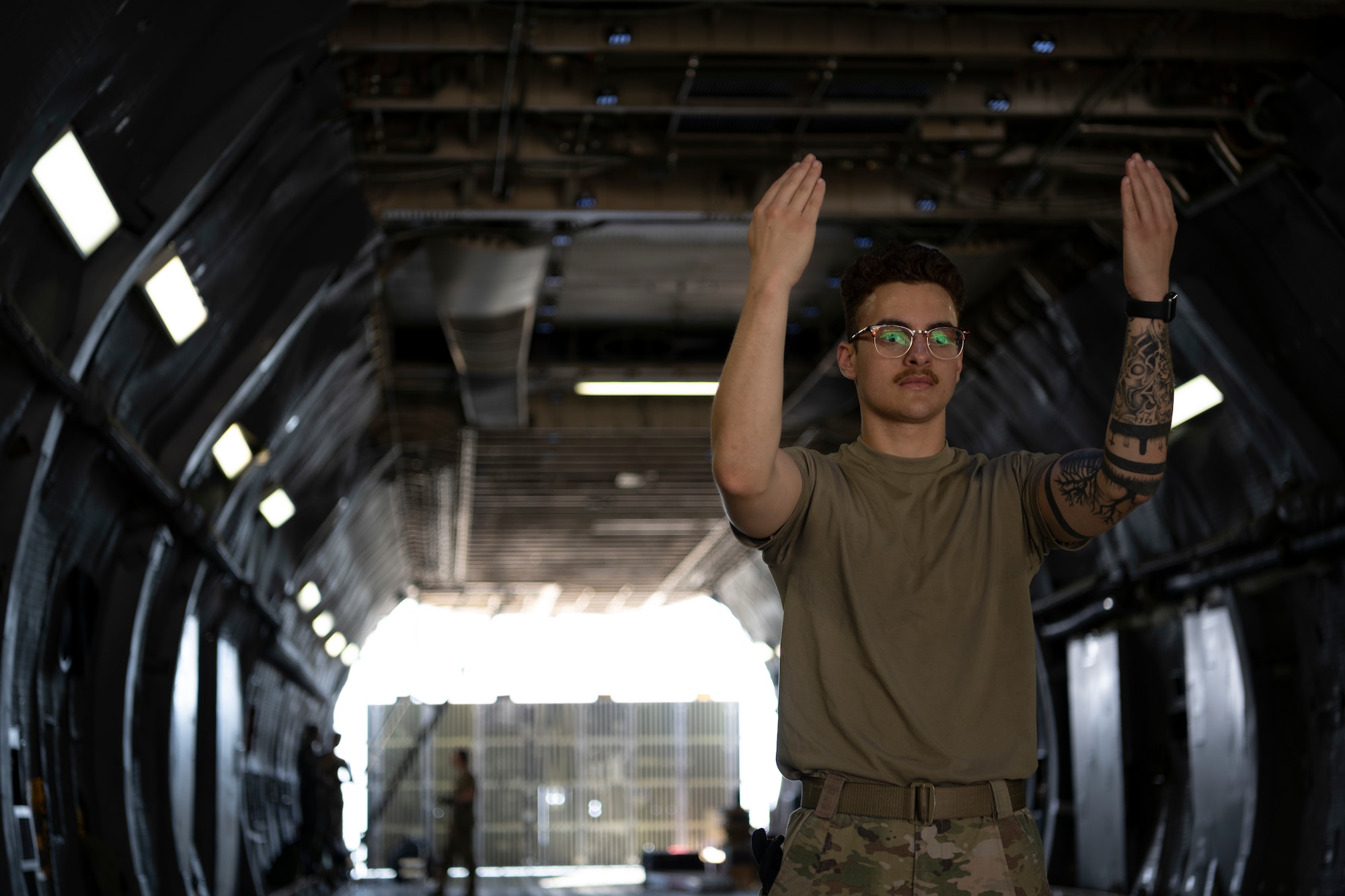 Airman with hands arms up marshalling