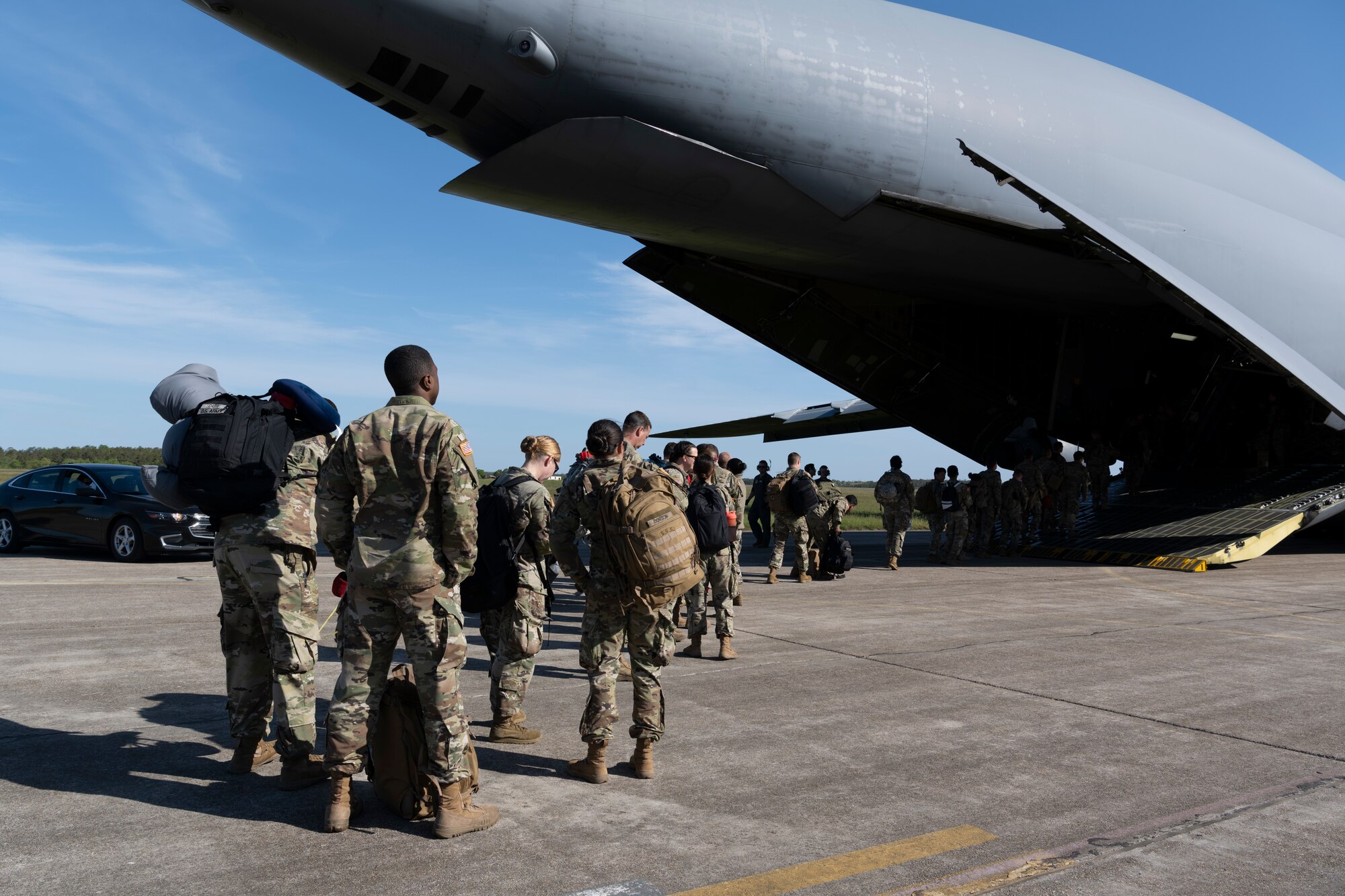 Soldiers line up to board a plane