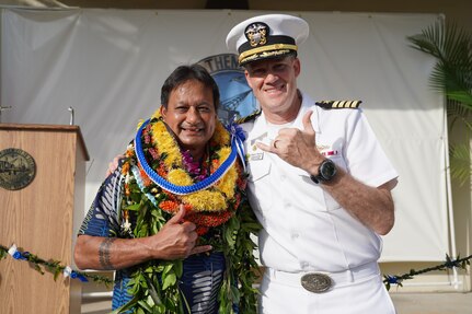 Mr. Kaipo Crowell celebrates his retirement with Captain Greg Burton, PHNSY & IMF Commander.