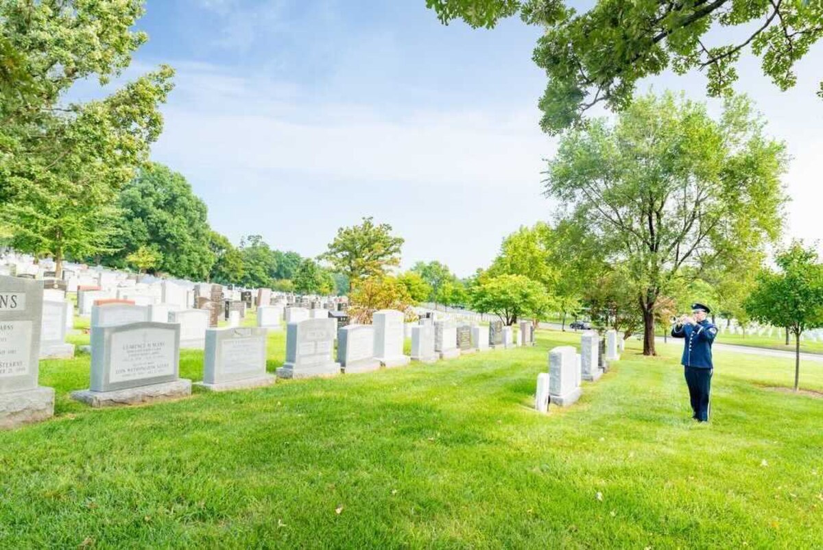 Trumpeter Master Sgt. Matthew Misener sounding Taps on a beautiful day at Arlington National Cemetery (U.S. Air Force photo by Master Sgt. (ret.) Brandon Chaney)