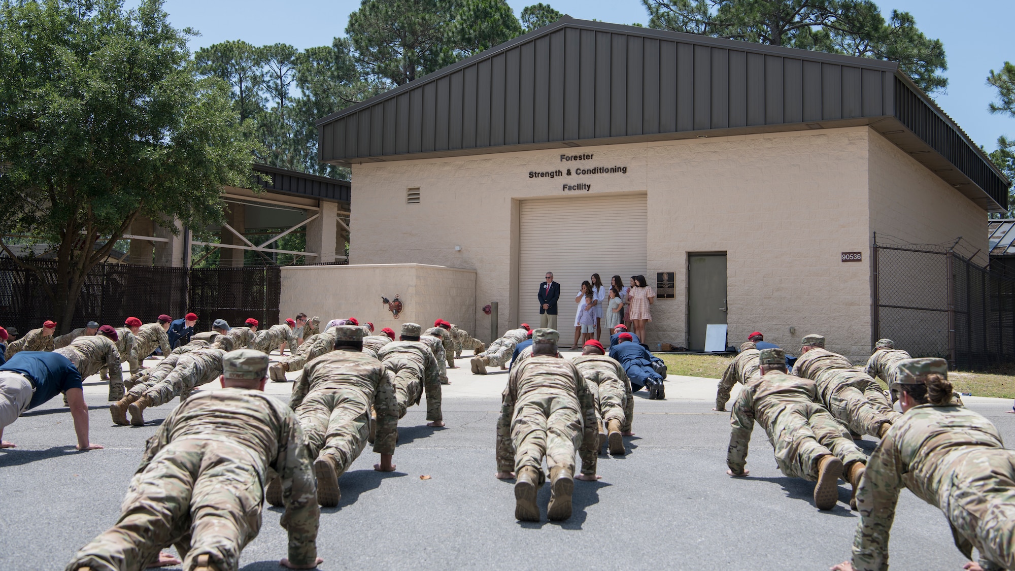 Members of the 24th Special Operations Wing perform memorial pushups in front of the newly-named Forester Strength and Conditioning Facility after a ceremony at Hurlburt Field, Florida, May 27, 2010.