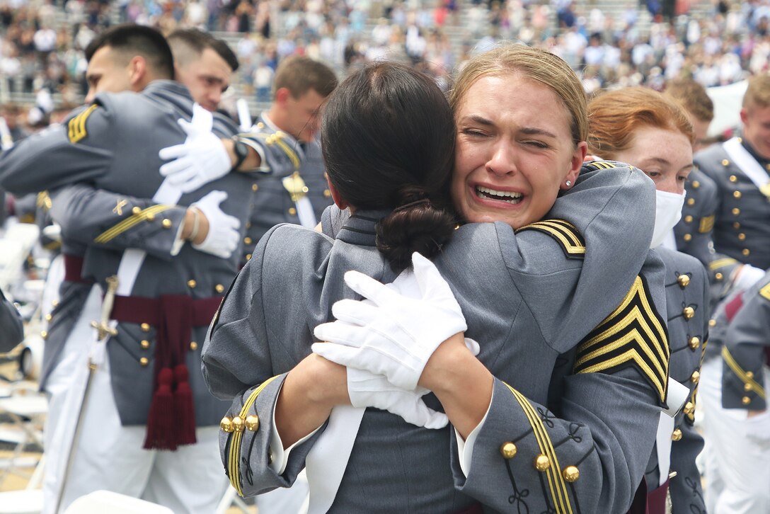 A crying soldier embraces another.