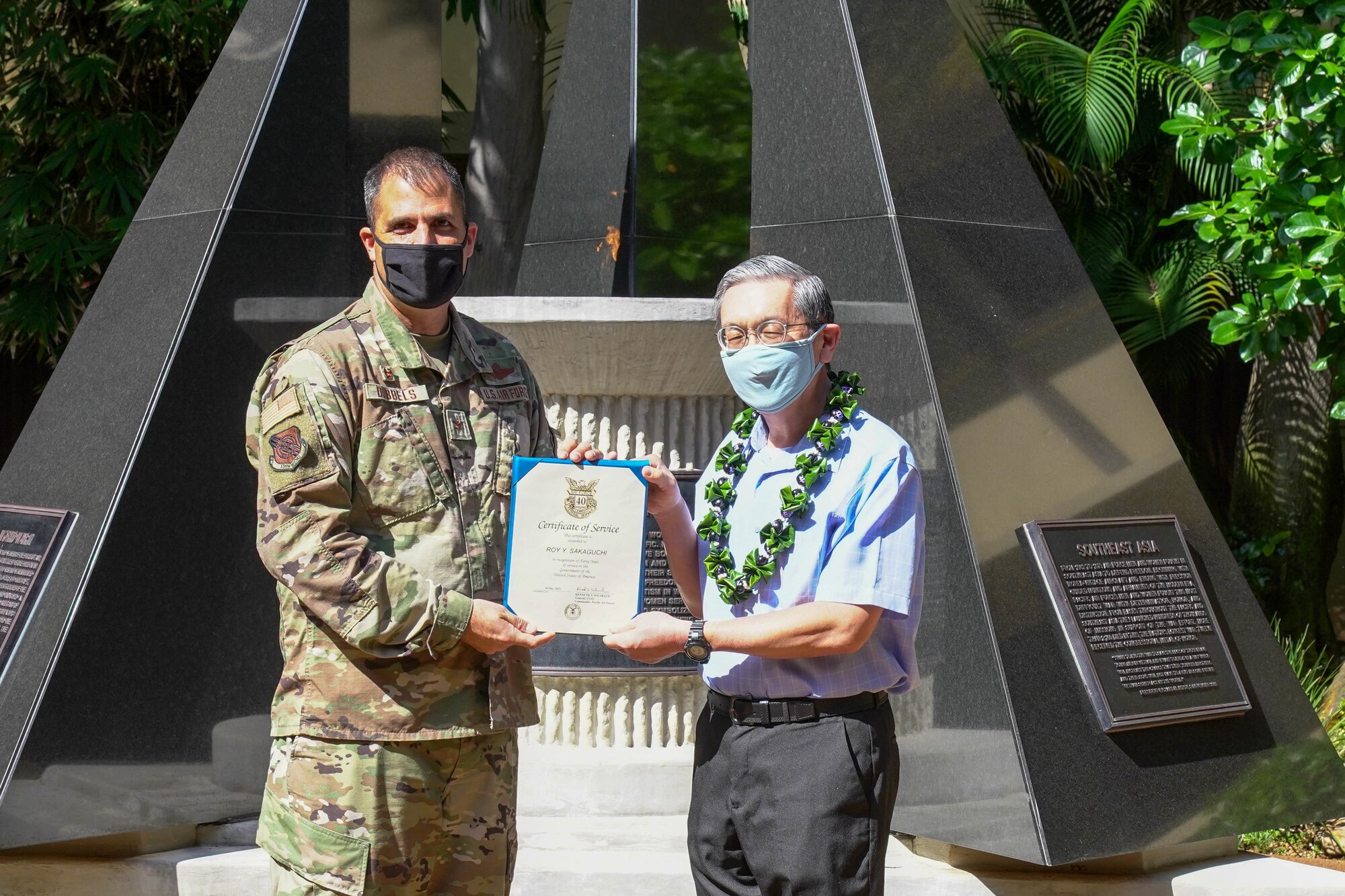 Col. Daniel Dobbels, 15th Wing commander, congratulates Roy Sakaguchi, 747th Communications Squadron project manager, on 40 years of service at Joint Base Pearl Harbor-Hickam, Hawaii, May 13, 2021. Sakaguchi started working at the 15th Communication Squadron, that later became the 747th Communications Squadron in 2010 after transferring from Wheeler Air Force Base. (U.S. Air Force photo by Airman 1st Class Makensie Cooper)