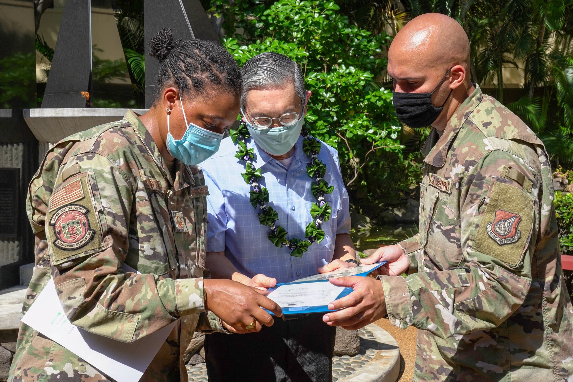 Master Sgt. Camille Carrington, 747th Communications Squadron flight chief, and Tech. Sgt. Isaac Logan, 747th CS section chief, congratulate Roy Sakaguchi, 747th CS project manager,  on his 40 years of service at Joint Base Pearl Harbor-Hickam, Hawaii, May 13, 2021. Sakaguchi, a Hawaiian native, started his career in 1981. (U.S. Air Force photo by Airman 1st Class Makensie Cooper)