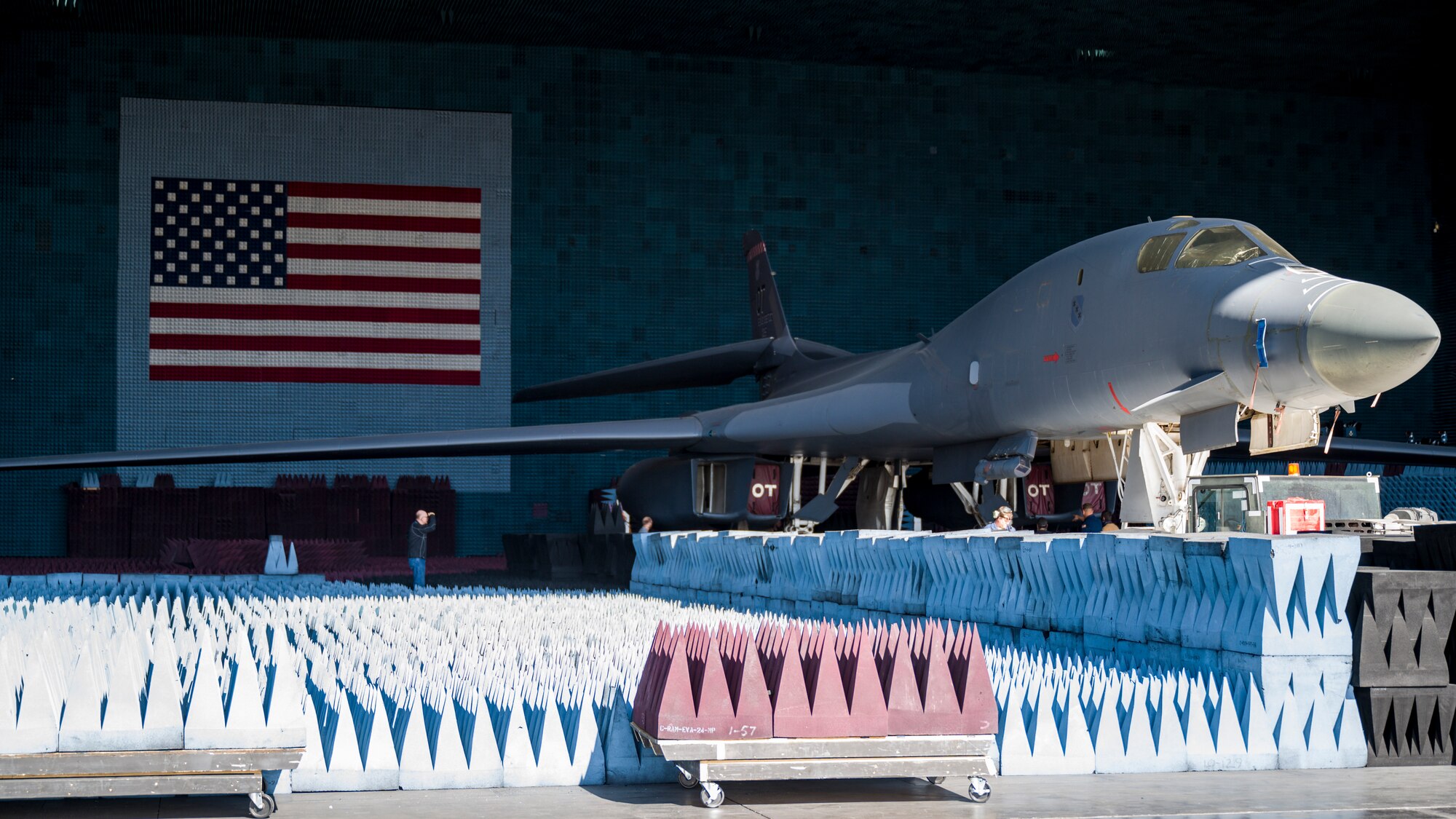 PFS 6.42 project test lead engineer, Capt. Shawn Whitney, BAF project engineer, 1st Lt. Kevin Lasquete, and BAF Project Manager, Justin Duhart, pose for a photo in front of a B-1B Lancer inside the Benefield Anechoic Facility at Edwards Air Force Base, California, May 20. The Lancer, from the 337th Test and Evaluation Squadron, 53rd Wing, out of Dyess Air Force Base, Texas, will be used to conduct testing of PFS 6.42. (Air Force photo by Giancarlo Casem)