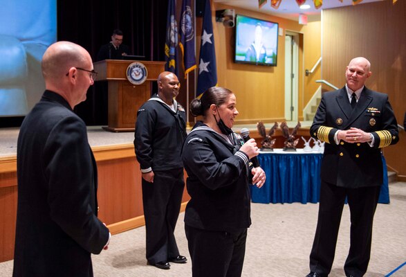Adm. Christopher W. Grady, commander, U.S. Fleet Forces Command (USFFC), right, and USFFC Fleet Master Chief Rick O�Rawe, left, listen to USFFC 2020 Sea Sailor of the Year (SOY) Personnel Specialist 1st Class Felicia Oxendine, Commander, Carrier Strike Group Ten, center, speak during a ceremony at the Joint Forces Staff College, May 27, 2021.