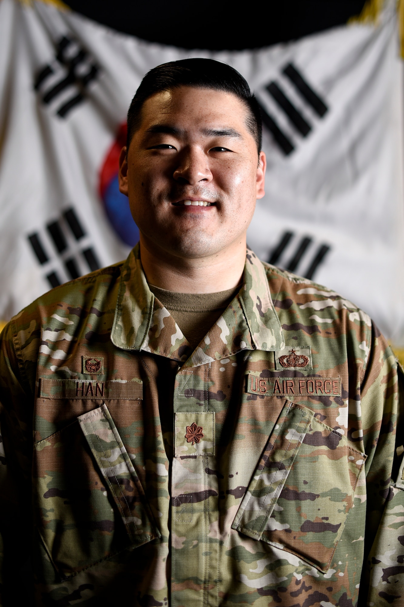 Maj. Samuel Han, 8th Comptroller Squadron commander, poses for a photo at Kunsan Air Base, Republic of Korea, May 27, 2021. Han’s family immigrated from Busan, South Korea, to Mission Viejo, California, where he and his brother grew up as the only Asians in his community. He joined the Air Force to pay the nation back and thank them for the opportunities his family had since moving to the United States. (U.S. Air Force photo by Senior Airman Suzie Plotnikov)
