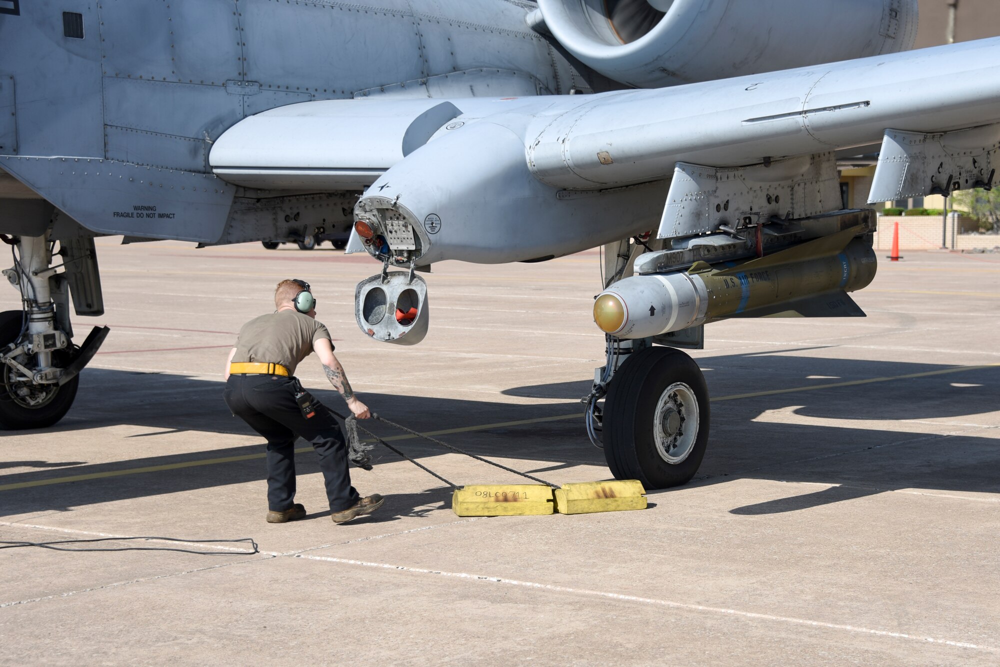 Crew chief pulls the chocks from the wheel of an A-10