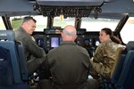 Maj. Gen. Craig Wills, 19th Air Force commander, and Chief Master Sgt. Kristina Rogers, 19th AF command chief master sergeant, talk with Col. James C. “JC” Miller, 433rd Operations Group commander, in the cockpit of a C-5M Super Galaxy at Joint Base San Antonio-Lackland, Texas, May 21, 2021. Wills and Rogers toured the 433rd Airlift Wing and discussed the pilot training transformation initiative.  (U.S. Air Force photo by Senior Airman Brittany Wich)