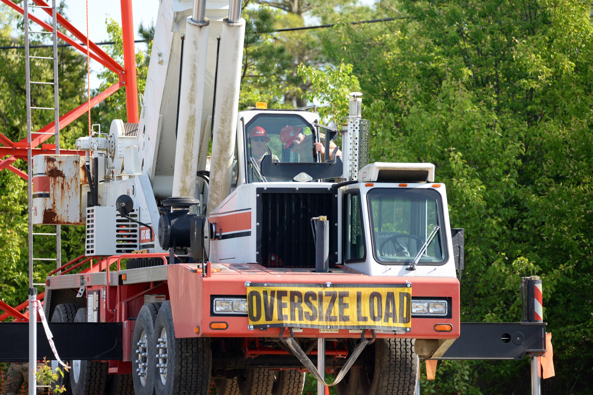 An image of Regional Equipment Operators Training Site instructors with the 201st Red Horse Squadron, 193rd Special Operations Wing, Ft. Indiantown Gap, PA, operating a mobile crane used to lift a section of radio communications tower.