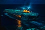 The Nimitz-class aircraft carrier USS Ronald Reagan (CVN 76) transits the Philippine Sea at night.