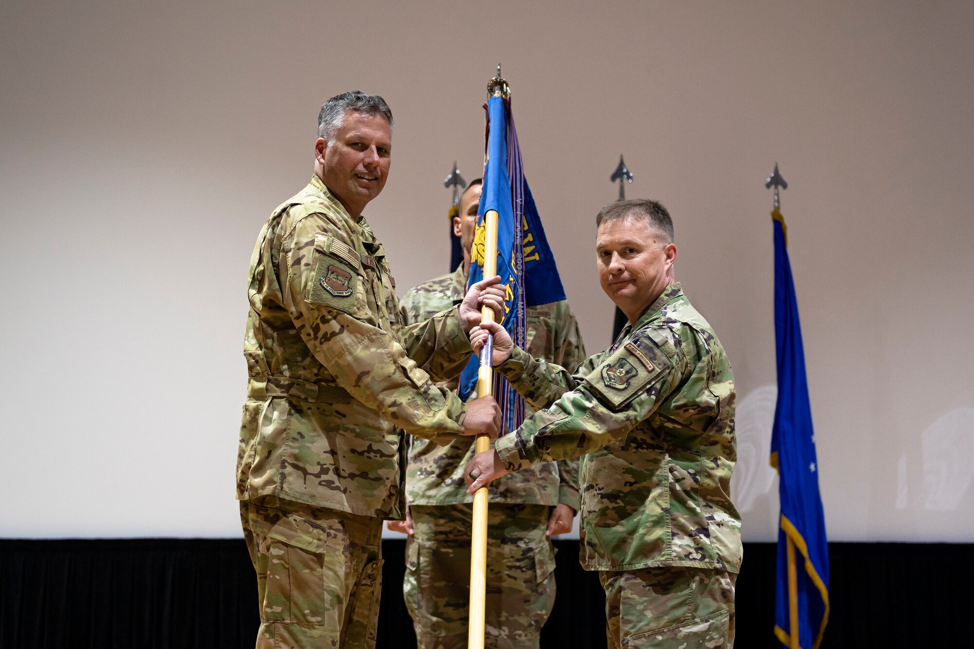 A photo of Airmen holding a guidon
