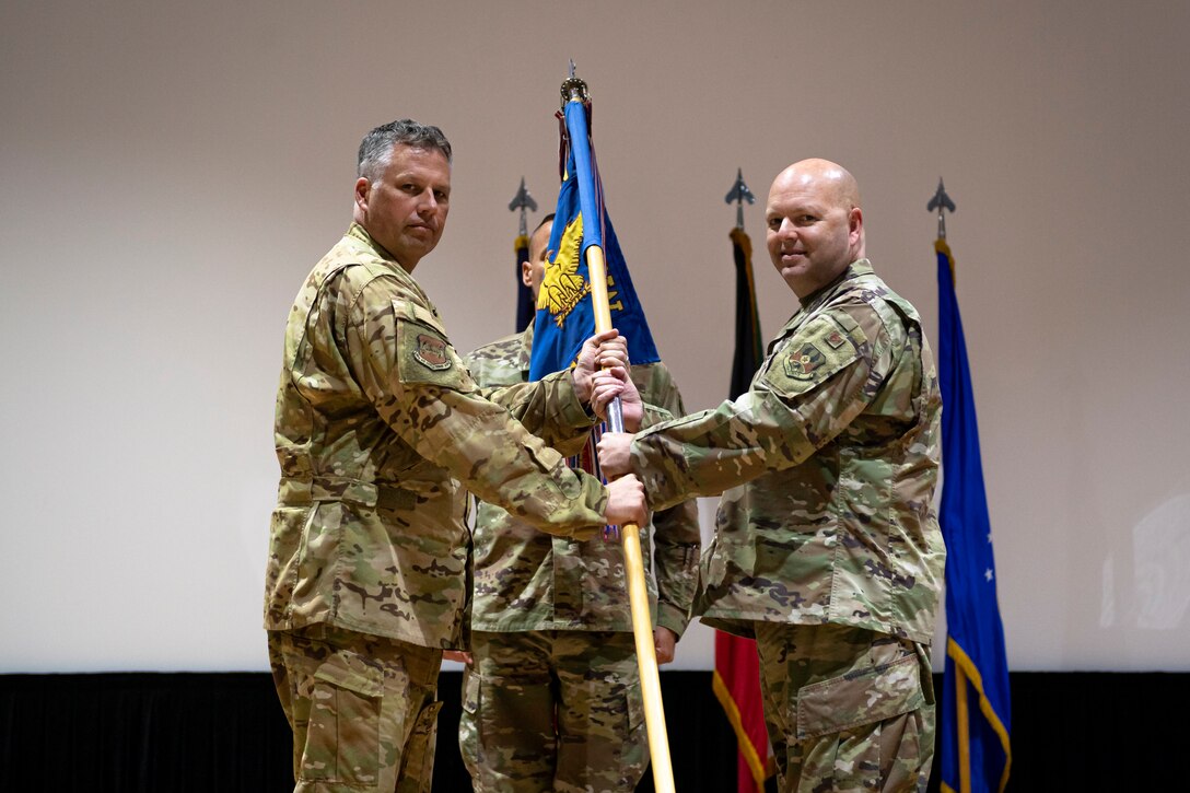 A photo of Airmen holding a guidon