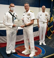 GREAT LAKES, Ill. (May 27, 2021) Rear Adm. Pete Garvin, commander, Naval Education and Training Command presents the Navy and Marine Corps Commendation Medal to Interior Communications Electrician 1st Class Robert Copeland III for his selection as the 2020 NETC Sailor of the Year. Fifteen finalists for SOY serving throughout the MyNavy HR Force Development domain rose through a number of competitions to represent the top achievers in recruiting and training from a pool of more than 4,490 military members. (U.S. Navy photo by Matt Mogle/Released)