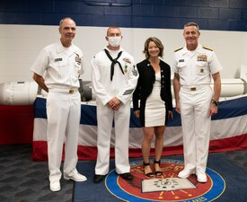 GREAT LAKES, Ill. (May 27, 2021) Interior Communications Electrician 1st Class Robert Copeland III and his wife Crystal poses with Rear Adm. Pete Garvin, commander, Naval Education and Training Command and Force Master Chief Matthew Harris during an award ceremony where Copeland was selected as the 2020 NETC Sailor of the Year. Fifteen finalists for SOY serving throughout the MyNavy HR Force Development domain rose through a number of competitions to represent the top achievers in recruiting and training from a pool of more than 4,490 military members. (U.S. Navy photo by Matt Mogle/Released)