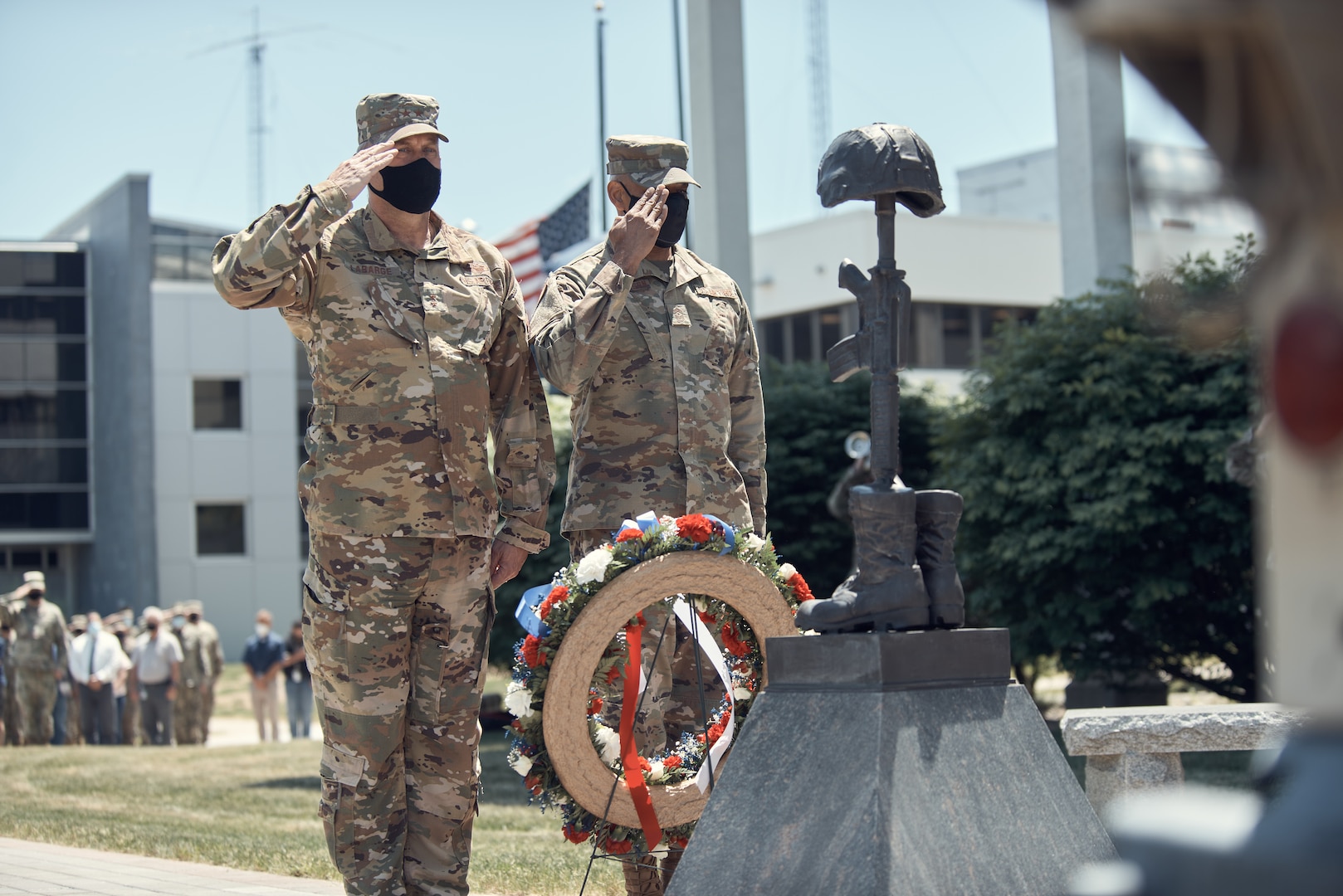 Air Force Maj. Gen. Timothy LaBarge, assistant adjutant general for New York, and Air Force Command Chief Master Sgt. Denny Richardson, state command chief for New York, render honors while taps is played during a Memorial Day service in Latham, N.Y., May 27, 2021. Each year the facility holds a service to recognize New York Guardsman who died the previous year.