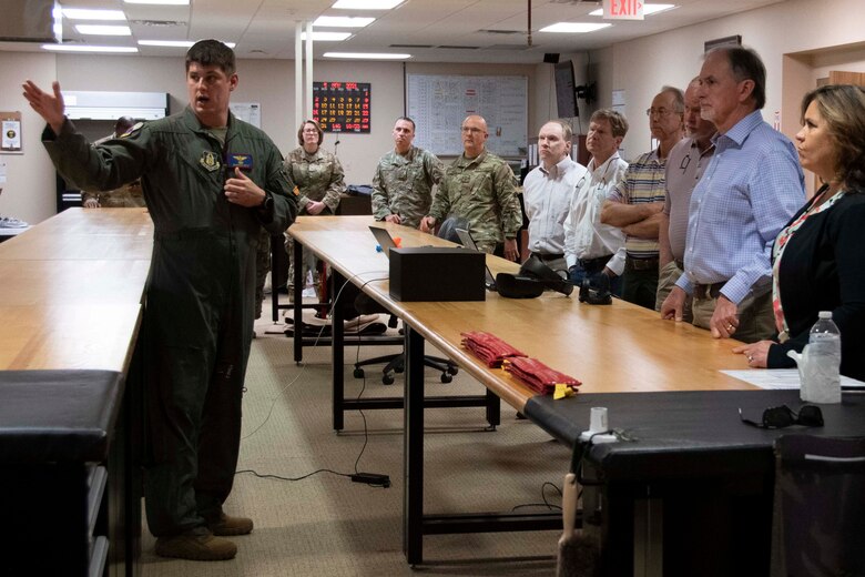 A pilot speaks to a group of civilians.