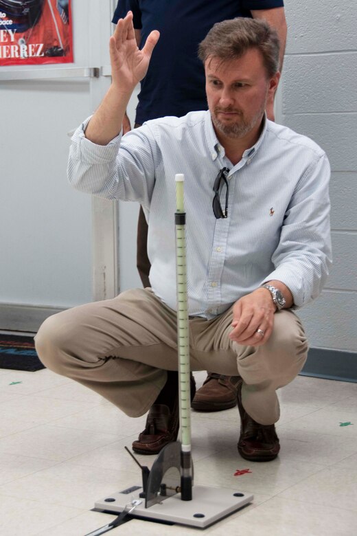 Civilian performs a straw rocket experiment.