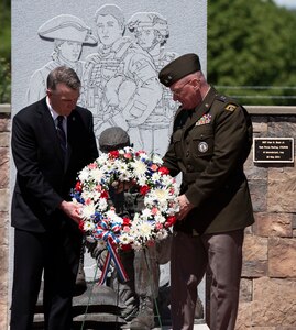 Gov. Phil Scott and Maj. Gen. Greg Knight, Vermont’s adjutant general, lay a wreath at the Fallen Heroes Memorial during a rededication ceremony at Camp Johnson, Vermont, May 27, 2021. The laying of flowers is custom for dedicating the graves of fallen service members as part of Memorial Day observances. (U.S. Army National Guard photo by Don Branum)