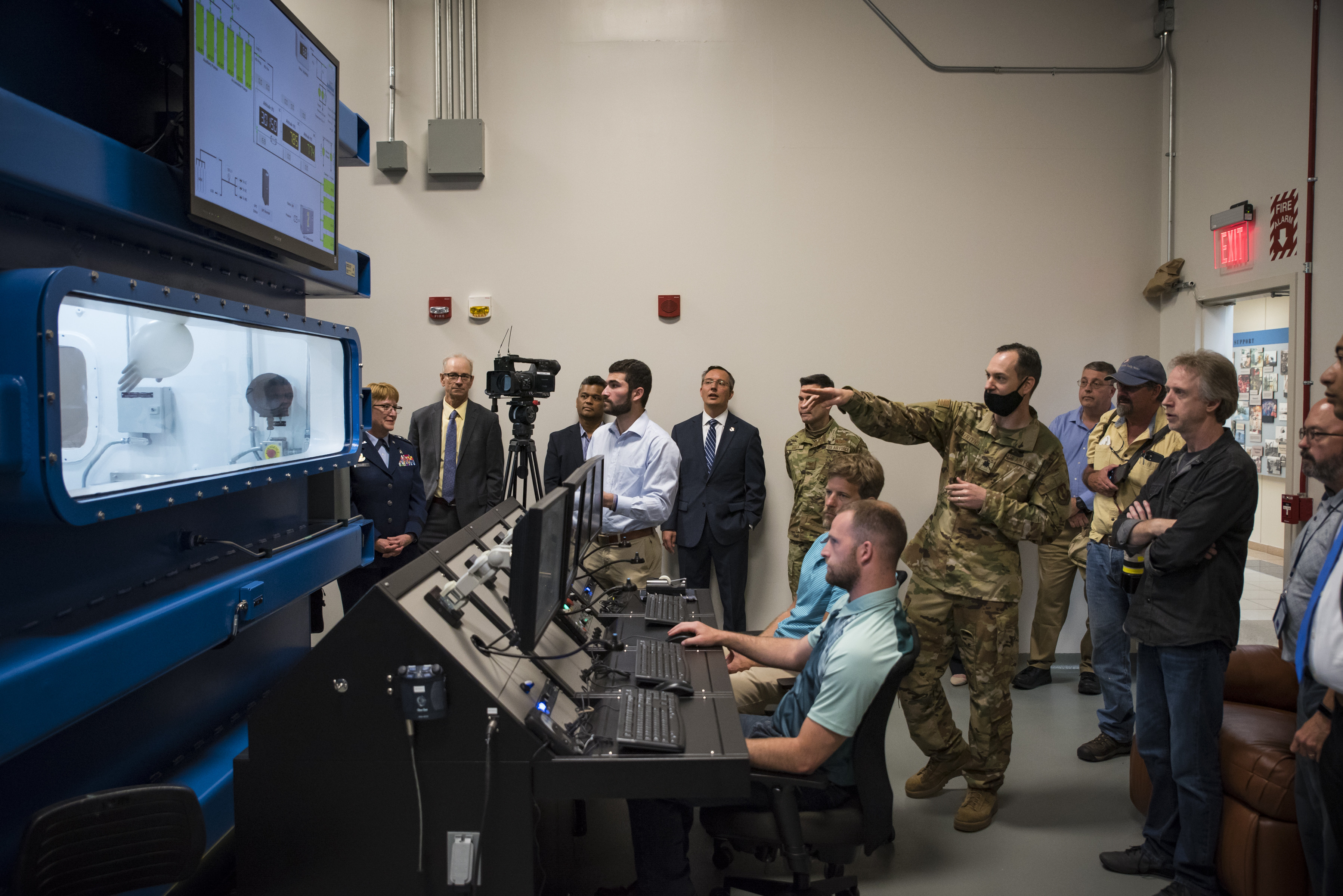 Lt. Col. Nathan Maertens, aerospace physiology division chief in the 711th Human Performance Wing, describes a decompression demonstration in research altitude chamber one following a ribbon-cutting ceremony May 27 hosted by the Air Force Research Laboratory’s 711 HPW. (U.S. Air Force photo by Richard Eldridge)