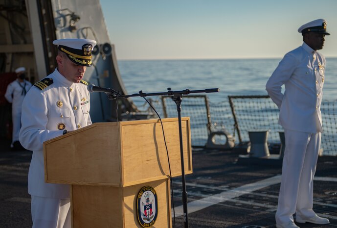 Fire Controlman 1st Class Daniel Thayer from Durango, Colorado, left, and Lieutenant Junior Grade Dwayne Williams from Pearland, Texas, participate in a wreath laying ceremony held in commemoration of the 63rd anniversary of the burial at sea in honor of the Tomb of the Unknown Soldier aboard the guided-missile destroyer USS Truxton (DDG-103). Truxton is currently underway conducting Ready Five qualifications