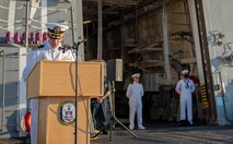 Fire Controlman 1st Class Daniel Thayer from Durango, Colorado, left, and Lieutenant Junior Grade Dwayne Williams from Pearland, Texas, participate in a wreath laying ceremony held in commemoration of the 63rd anniversary of the burial at sea in honor of the Tomb of the Unknown Soldier aboard the guided-missile destroyer USS Truxton (DDG-103). Truxton is currently underway conducting Ready Five qualifications