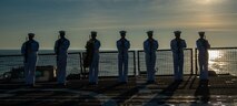 Fire Controlman 1st Class Daniel Thayer from Durango, Colorado, left, and Lieutenant Junior Grade Dwayne Williams from Pearland, Texas, participate in a wreath laying ceremony held in commemoration of the 63rd anniversary of the burial at sea in honor of the Tomb of the Unknown Soldier aboard the guided-missile destroyer USS Truxton (DDG-103). Truxton is currently underway conducting Ready Five qualifications