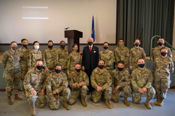 The Honorable Sichan Siv, former Ambassador to the United Nations, shakes hands with Tech. Sgt. Jamie Coffee during a commissioning announcement event at Travis Air Force Base, California.