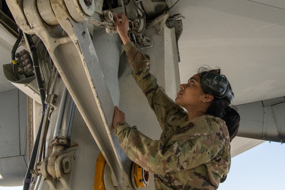 Airman 1st Class Sneha Lakshminarayanan, a crew chief with the 749th Aircraft Maintenance Squadron, works on a KC-10 Extender aircraft.