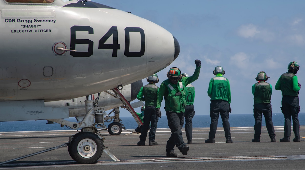 Aviation Boatswain's Mate (Equipment) 3rd Class Quentyn Brown, from Springfield, Georgia, directs an E-2D Hawkeye, attached to the "Greyhawks" of Airborne Command and Control Squadron (VAW) 120, on the flight deck of the Nimitz-class aircraft carrier USS Harry S. Truman (CVN 75) during carrier qualifications after completing an extended incremental availability.