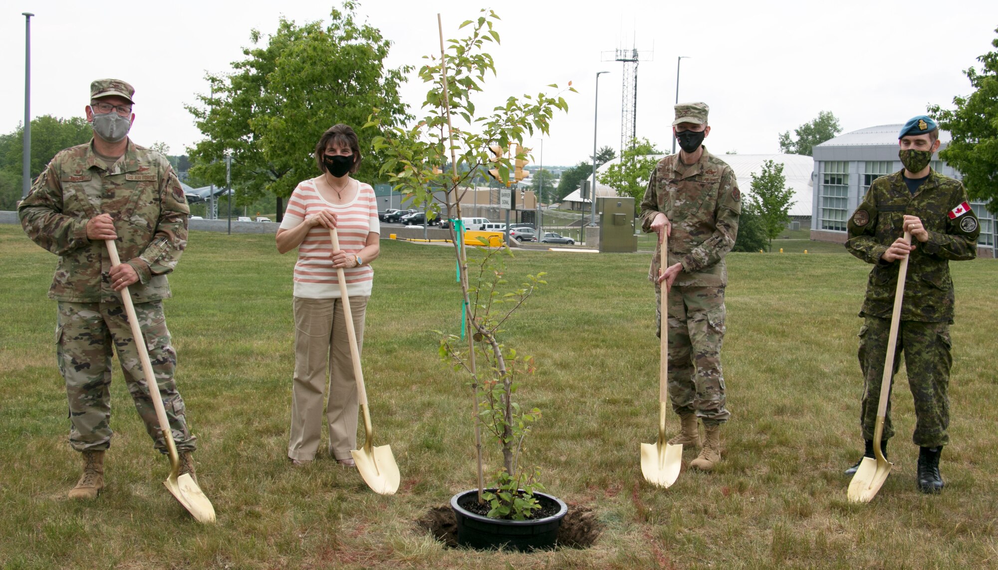 Left to right, Col. Paul M. Bishop, EADS commander; Rome Mayor Jackie Izzo; Col. Joseph F. Roos, 224th Air Defense Group commander, and Lt. Col. Josh Klemen, EADS Canadian Detachment commander, planted the 9/11 Survivor Tree seedling at EADS during a short ceremony May 26, 2021.  The seedling was taken from a tree found in the World Trade Center rubble in October 2001 and nursed back to health.