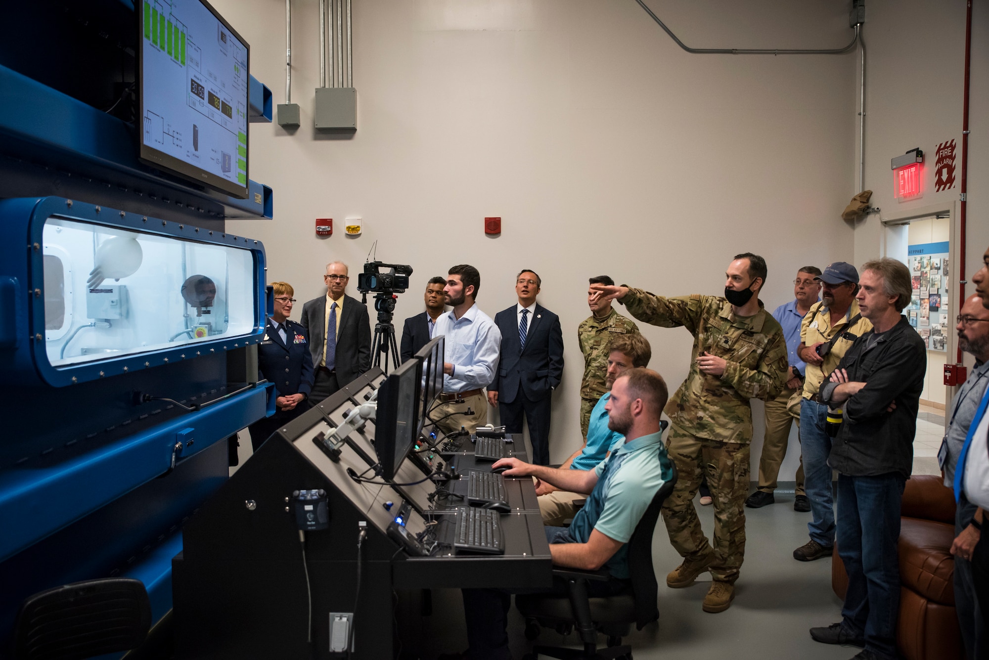 Lt. Col. Nathan Maertens, aerospace physiology division chief in the 711th Human Performance Wing, describes a decompression demonstration in research altitude chamber one following a ribbon-cutting ceremony May 27 hosted by the Air Force Research Laboratory’s 711 HPW. (U.S. Air Force photo by Richard Eldridge)