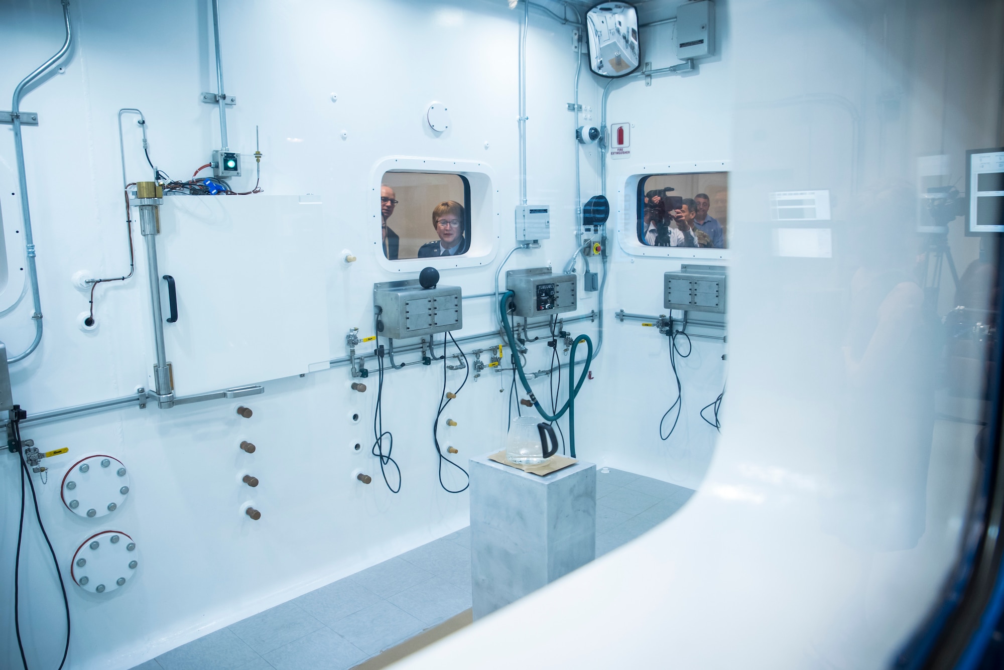 Lt. Gen. Dorothy Hogg, Air Force Surgeon General, watches a decompression demonstration through a window of research altitude chamber one following a ribbon-cutting ceremony May 27 hosted by the Air Force Research Laboratory’s 711 HPW. (U.S. Air Force photo by Richard Eldridge)