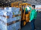 Logistics Specialist 1st Class Aaron Azuma, from Olongapo, Philippines, directs a cargo onload aboard the U.S. Navy’s only forward-deployed aircraft carrier, USS Ronald Reagan (CVN 76).