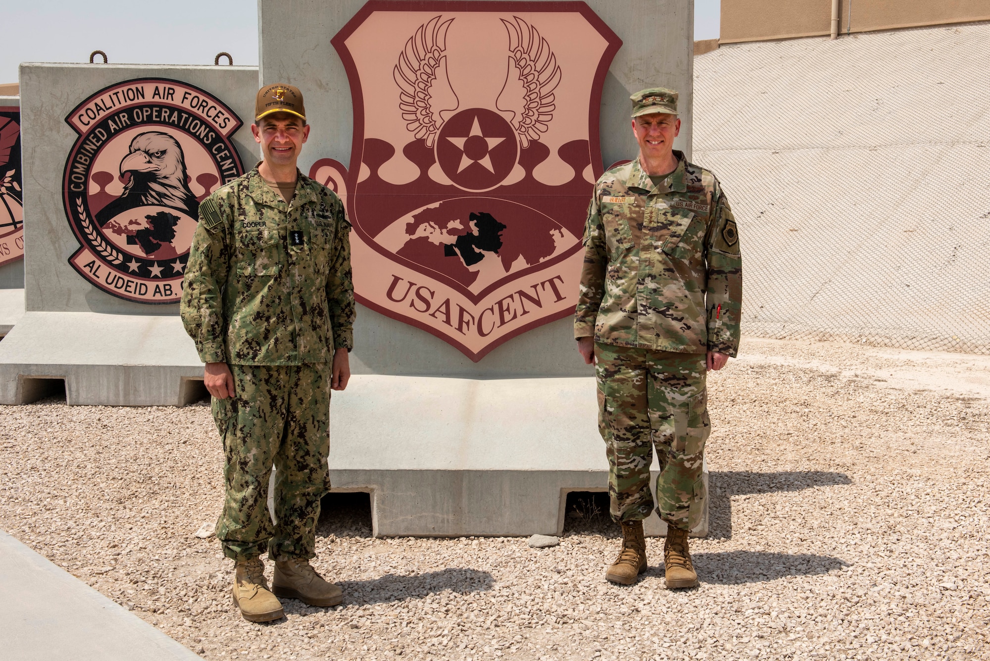 Vice Adm. Brad Cooper, U.S. Naval Forces Central Command/5th Fleet/Combined Maritime Forces commander, and Lt. Gen. Greg Guillot, 9th Air Force (Air Forces Central) commander, stand for a photo May 25, 2021, at Al Udeid Air Base, Qatar. Cooper visited the Combined Air Operations Center to observe the mission and discuss interoperability opportunities between the two commands. (U.S Air Force photo by Tech. Sgt. Dylan Nuckolls)