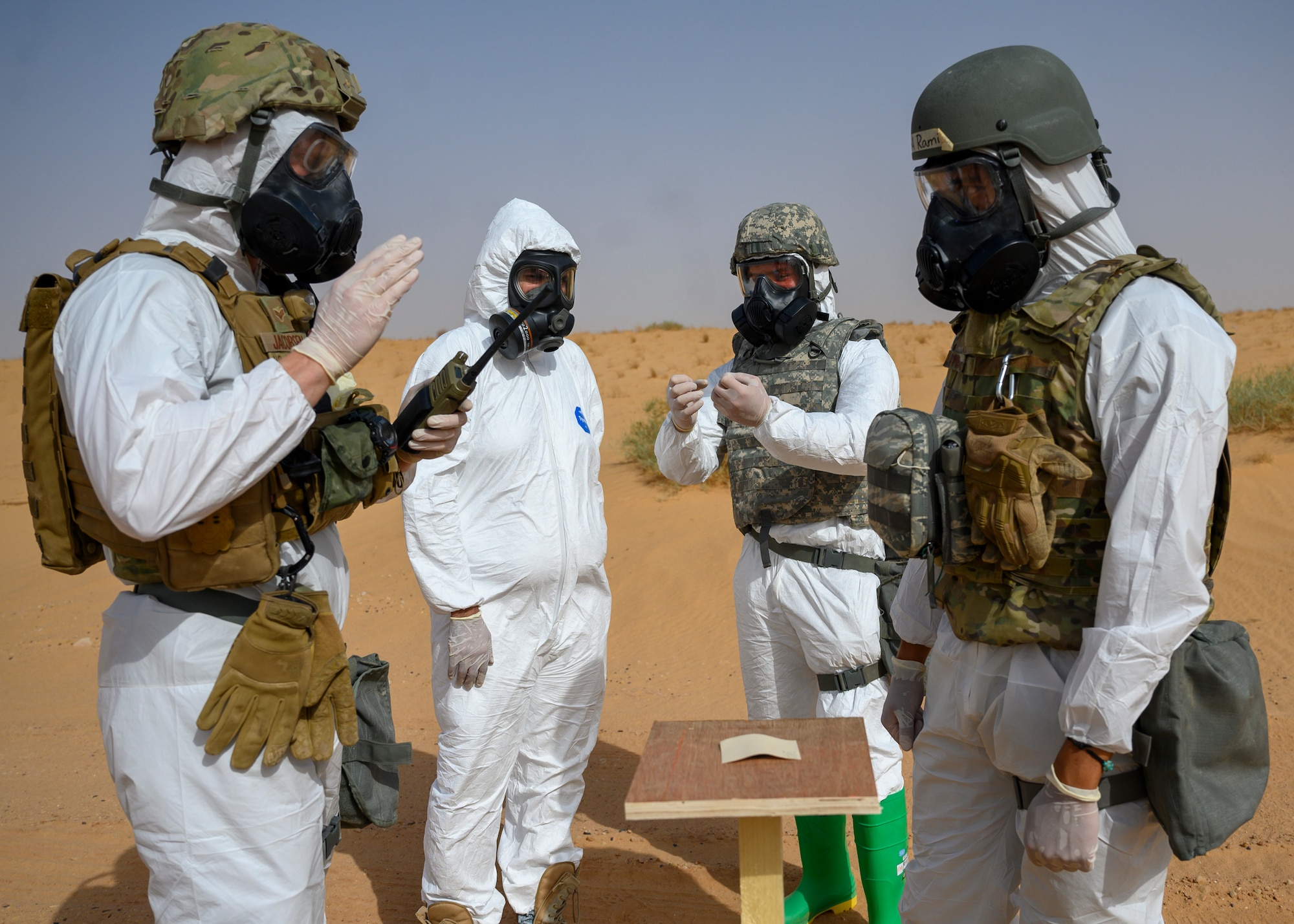 Members of the 378th Civil Engineer Squadron emergency management flight and members of the Royal Saudi Air Force discuss simulated readings on an M9 paper during a chemical, biological, radiological and nuclear response exercise, Prince Sultan Air Base, Kingdom of Saudi Arabia, May 26, 2021. The combined exercise demonstrates the emergency management integration between USAF and RSAF CBRN response units while also familiarizing each unit with the other’s techniques and procedures. (U.S. Air Force photo by Senior Airman Samuel Earick)