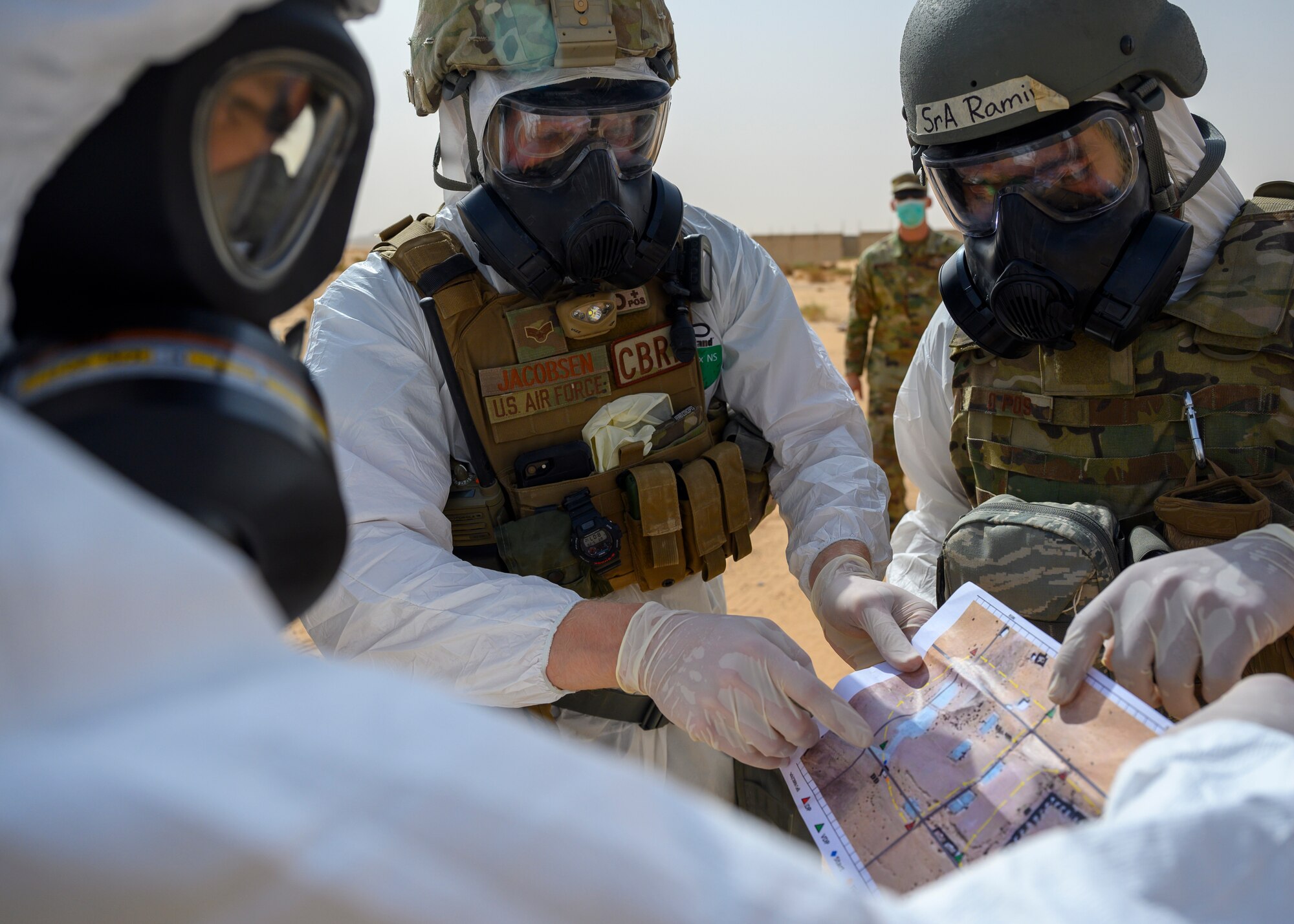 Members of the 378th Civil Engineer Squadron emergency management flight and members of the Royal Saudi Air Force discuss routes for a chemical, biological, radiological and nuclear response exercise, Prince Sultan Air Base, Kingdom of Saudi Arabia, May 26, 2021. The combined exercise demonstrates the emergency management integration between USAF and RSAF CBRN response units while also familiarizing each unit with the other’s techniques and procedures. (U.S. Air Force photo by Senior Airman Samuel Earick)
