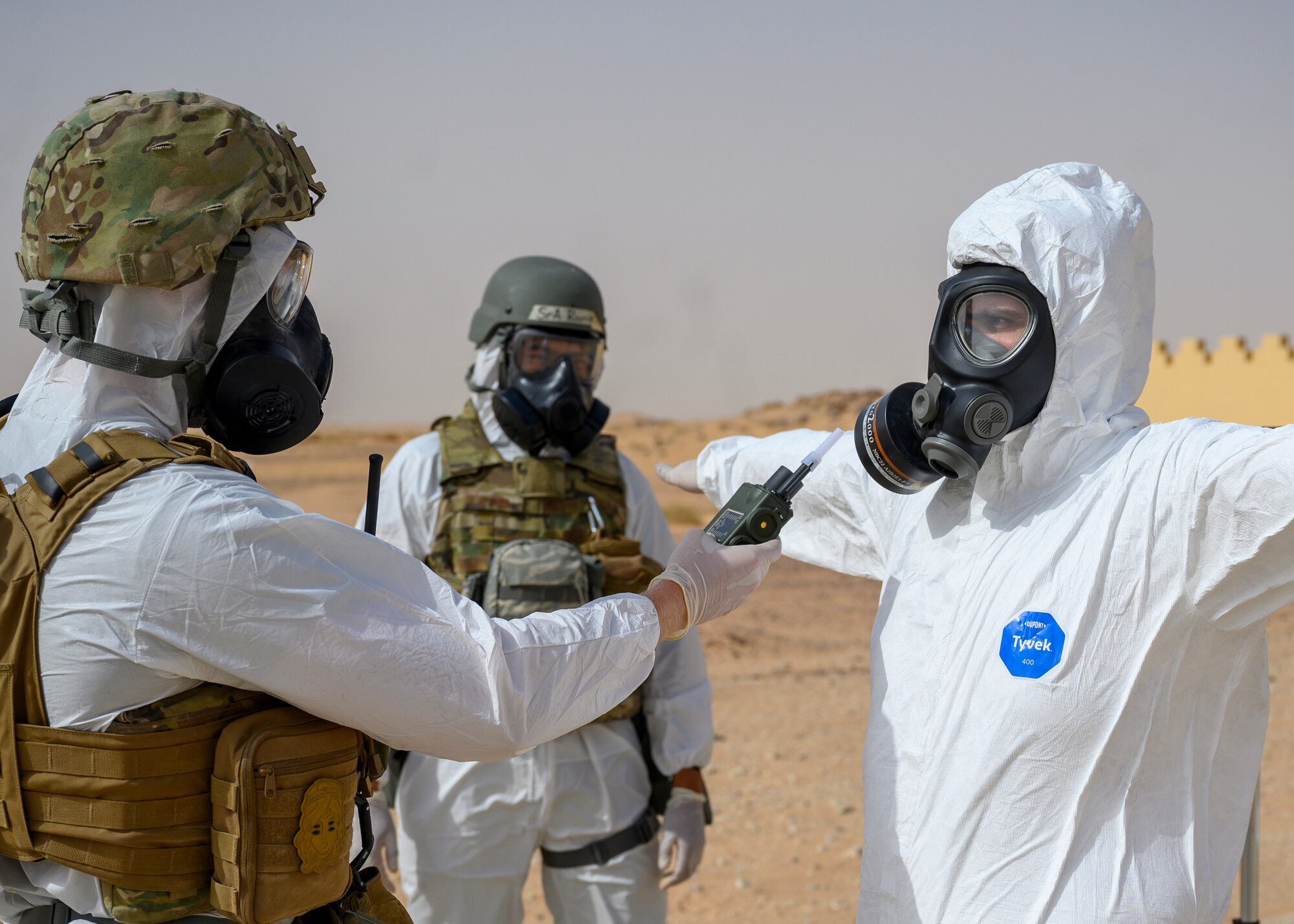 Members of the 378th Civil Engineer Squadron emergency management flight simulate checking for any contamination readings on members of the Royal Saudi Air Force after a chemical, biological, radiological and nuclear response exercise, Prince Sultan Air Base, Kingdom of Saudi Arabia, May 26, 2021. The combined exercise demonstrates the emergency management integration between USAF and RSAF CBRN response units while also familiarizing each unit with the other’s techniques and procedures. (U.S. Air Force photo by Senior Airman Samuel Earick)