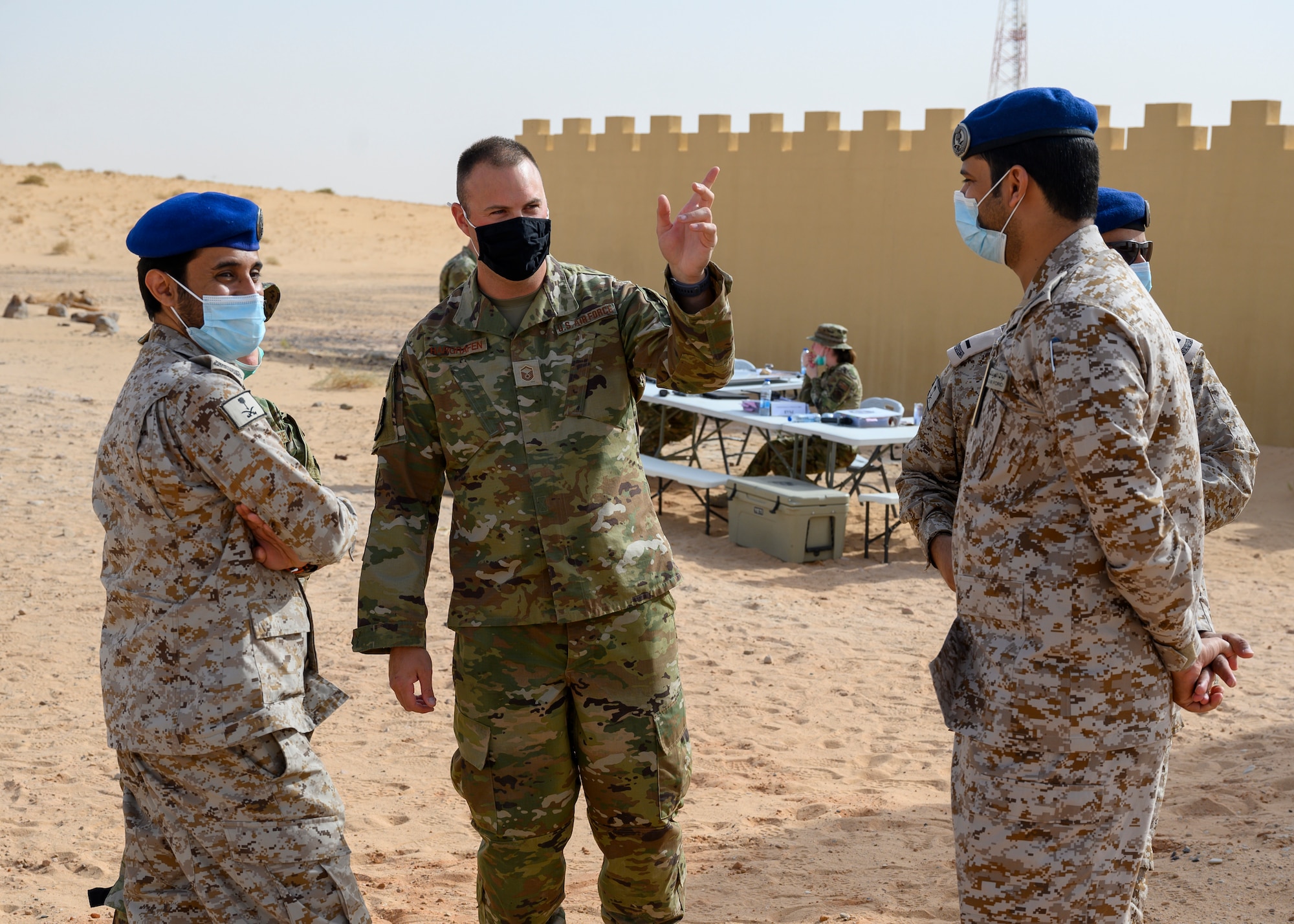 Master Sgt. Nathan Hargrafen, U.S. Air Force Master Sgt. Nathan Hargrafen, 378th Civil Engineer Squadron emergency management flight chief, explains the steps of  a chemical, biological, radiological and nuclear response exercise with members of the Royal Saudi Air Force, Prince Sultan Air Base, Kingdom of Saudi Arabia, May 26, 2021. The combined exercise demonstrates the emergency management integration between USAF and RSAF CBRN response units while also familiarizing each unit with the other’s techniques and procedures.  (U.S. Air Force photo by Senior Airman Samuel Earick)