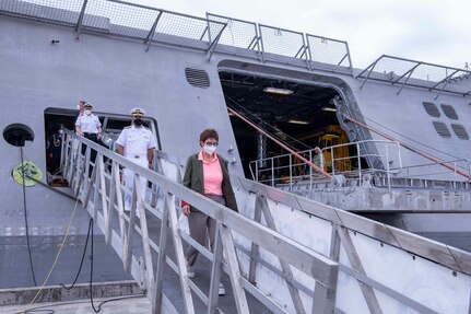 210528-N-WU807-1161 APRA HARBOR, Guam (May 28, 2021) German Defense Minister Annegret Kramp-Karrenbauer departs Independence-variant littoral combat ship USS Charleston (LCS 18), May 28. Charleston, part of Destroyer Squadron Seven, is on a rotational deployment operating in the U.S. 7th Fleet area of operation to enhance interoperability with partners and serve as a ready response force in support of a free and open Indo-Pacific region. (U.S. Navy photo by Mass Communication Specialist 3rd Class Adam Butler)