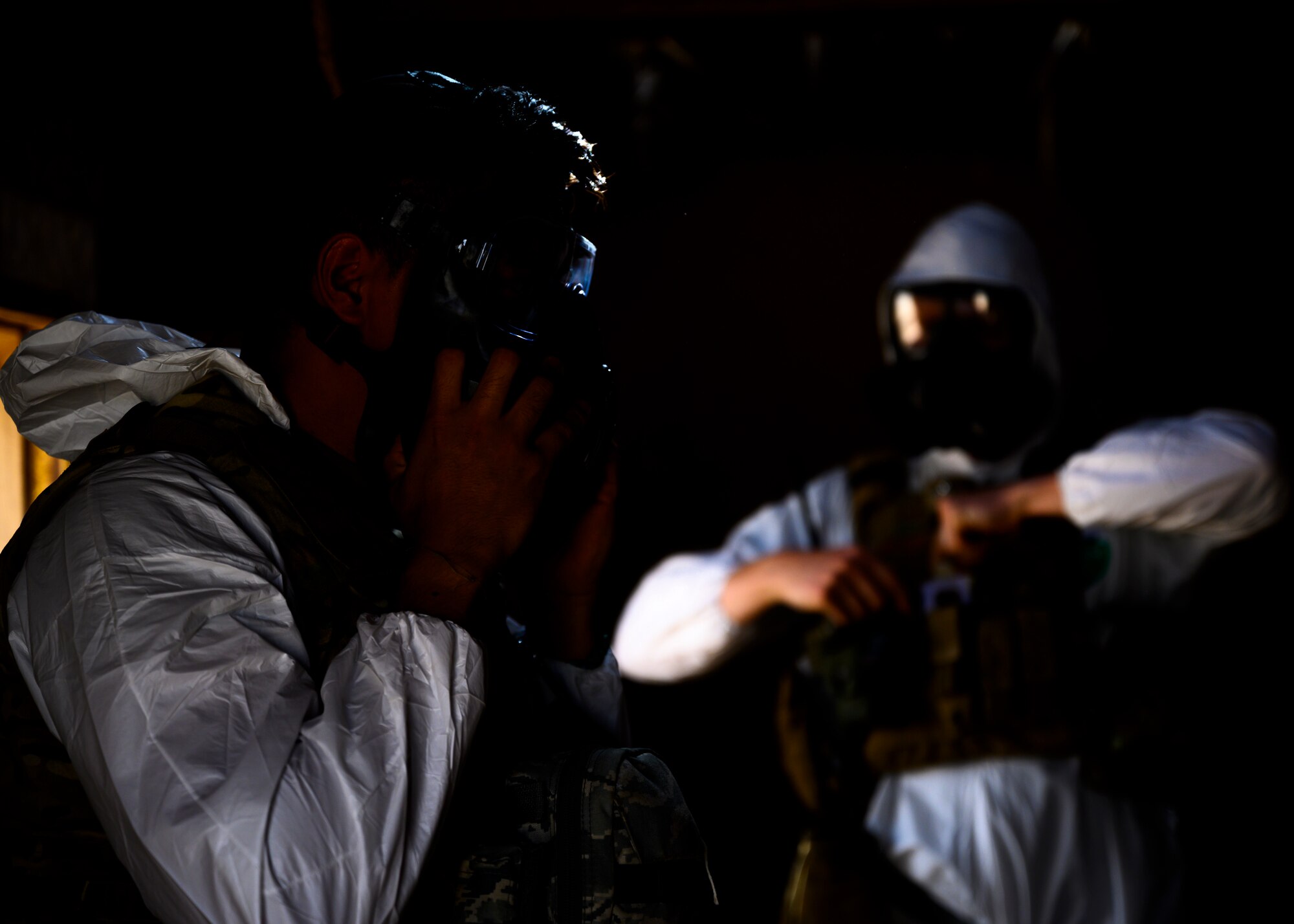 Members of the 378th Civil Engineer Squadron emergency management flight put on their Tyvek suits  during a chemical, biological, radiological and nuclear response exercise, Prince Sultan Air Base, Kingdom of Saudi Arabia, May 26, 2021. The combined exercise demonstrates the emergency management integration between USAF and RSAF CBRN response units while also familiarizing each unit with the other’s techniques and procedures. (U.S. Air Force photo by Senior Airman Samuel Earick)