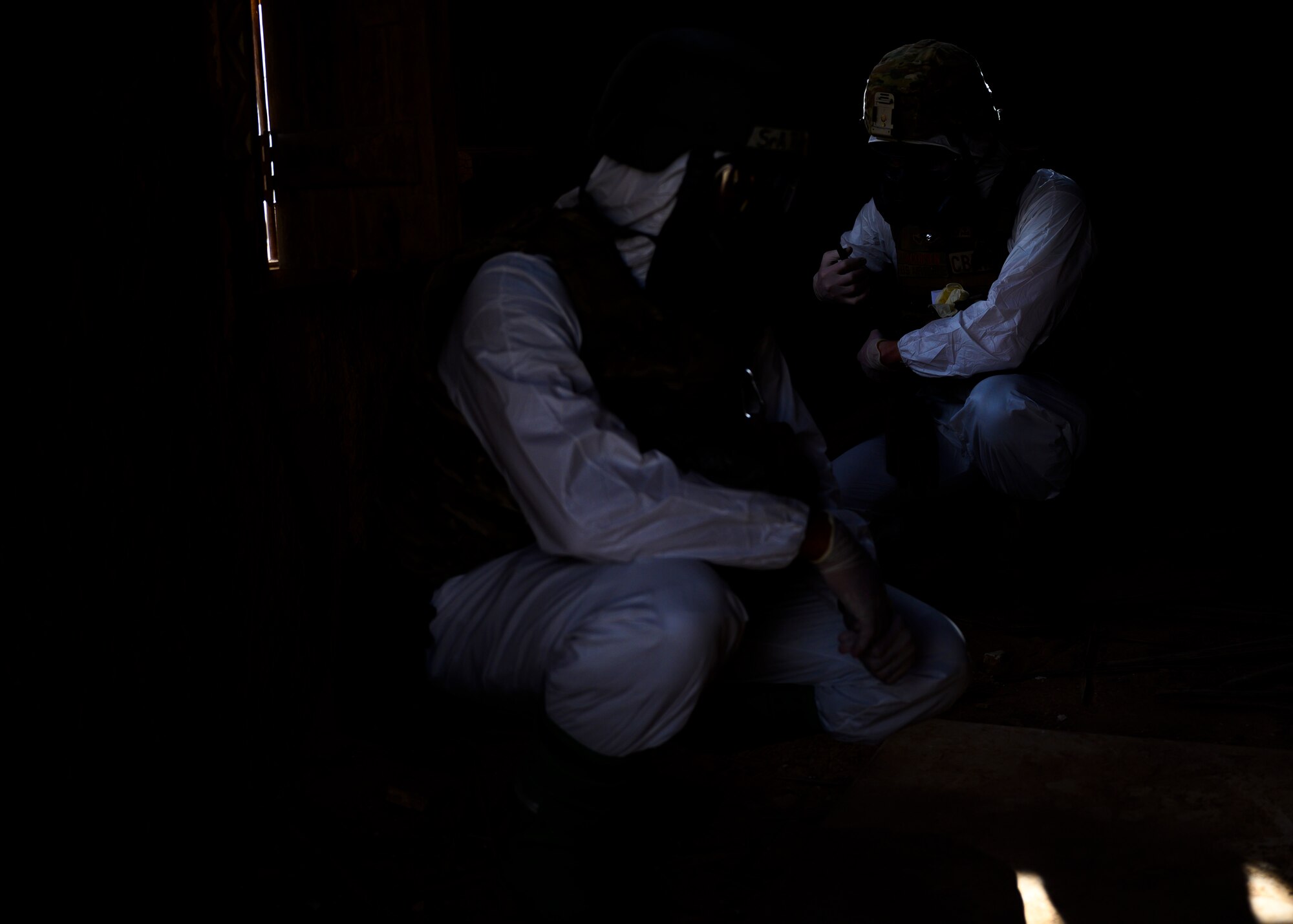 Members of the 378th Civil Engineer Squadron emergency management flight put on their Tyvek suits  during a chemical, biological, radiological and nuclear response exercise, Prince Sultan Air Base, Kingdom of Saudi Arabia, May 26, 2021. The combined exercise demonstrates the emergency management integration between USAF and RSAF CBRN response units while also familiarizing each unit with the other’s techniques and procedures. (U.S. Air Force photo by Senior Airman Samuel Earick)