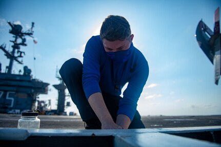 Aviation Boatswain's Mate (Handling) Airman Jerin Navel, from Martinsville, Indiana, cleans an aqueous film-forming foam station on the flight deck of the Nimitz-class aircraft carrier USS Harry S. Truman (CVN 75) during sea trials after completing an extended carrier incremental availability.