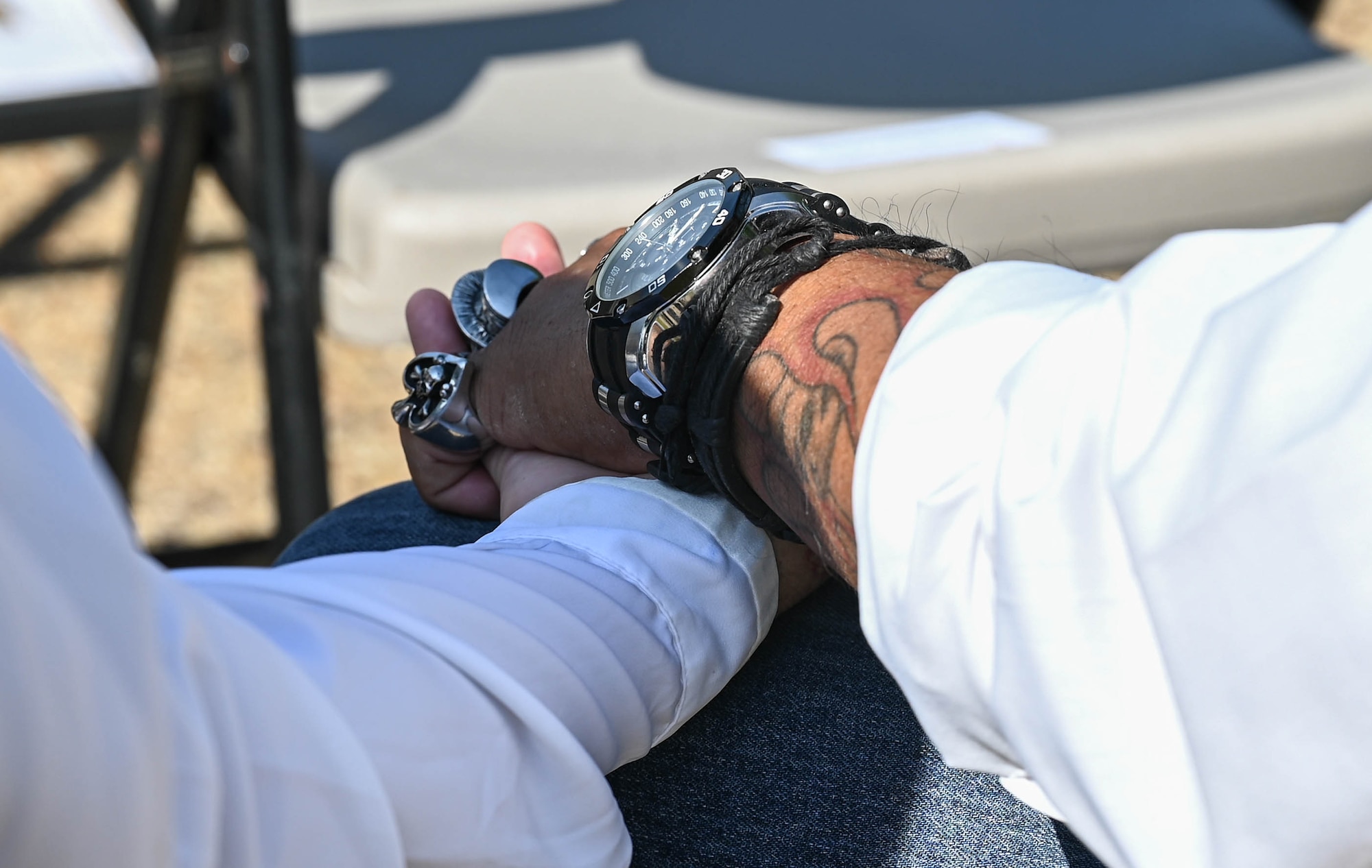 Two members of the Patriot Guard Riders, hold hands during the Memorial Day retreat ceremony at Joint Base Langley-Eustis, Virginia, May 27, 2021. The Patriot Guard Riders were founded in 2005 to shield families of fallen heroes. (U.S. Air Force photo by Senior Airman Sarah Dowe)