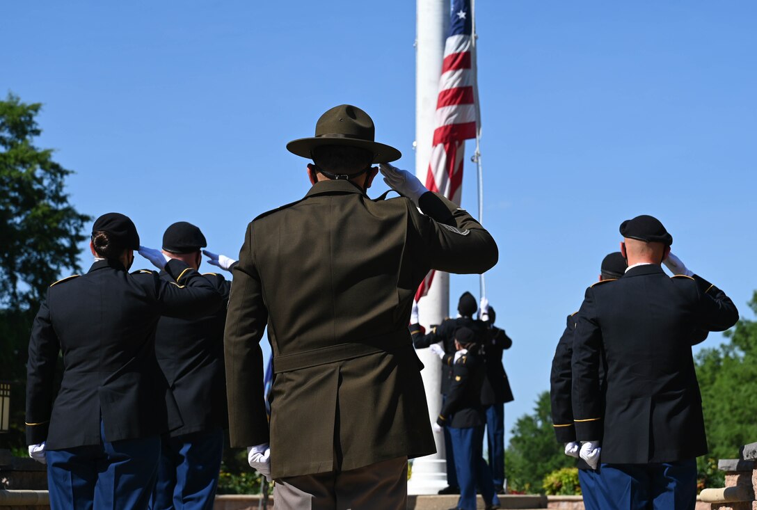 U.S. Army Advanced Individual Training Soldiers lower the United States Flag during the Memorial Day retreat ceremony at Joint Base Langley-Eustis, Virginia, May 27, 2021. The Soldiers were directed by a drill sergeant and folded the flag at his command. (U.S. Air Force photo by Senior Airman Sarah Dowe)