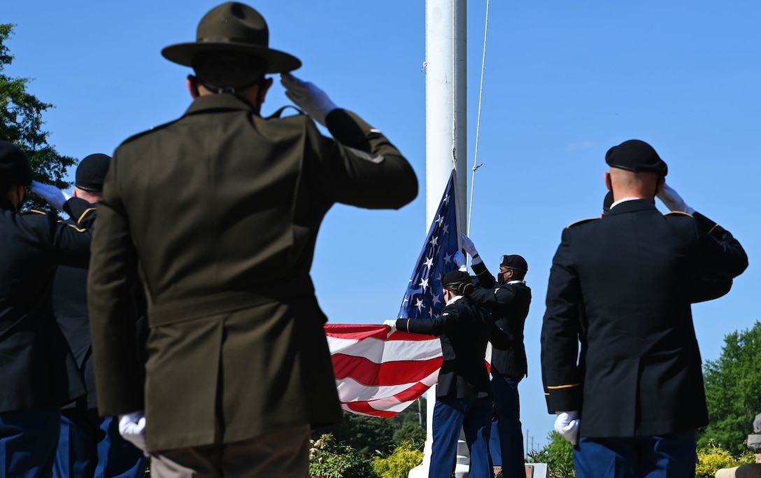 U.S. Army Advanced Individual Training Soldiers lower the United States Flag during the Memorial Day retreat ceremony at Joint Base Langley-Eustis, Virginia, May 27, 2021. The Soldiers were directed by a drill sergeant and folded the flag at his command. (U.S. Air Force photo by Senior Airman Sarah Dowe)